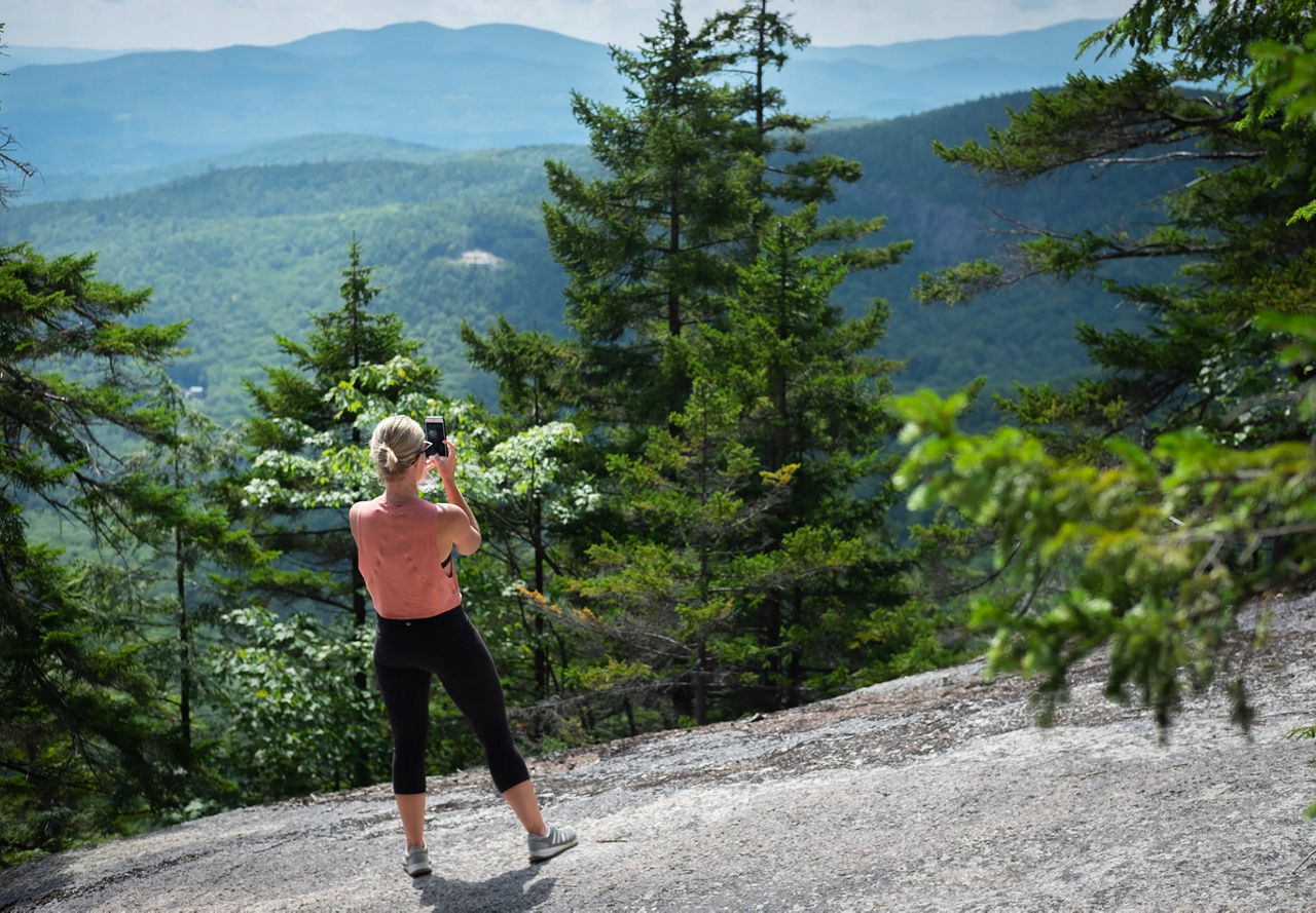 Woman hiking | Photo by Daniel Norris on Unsplash | Greystar